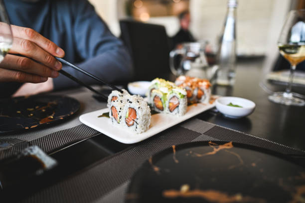 istock Eating salmon rolls in a restaurant. 2153829196