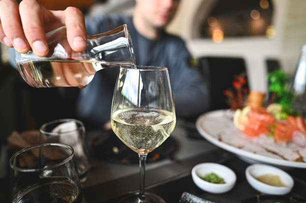 istock Pouring white wine in a wineglass. 2153829259