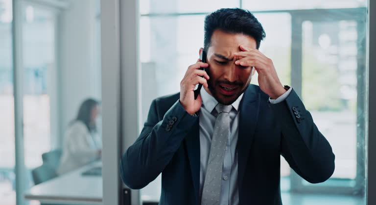 Man, phone call and stress in office for mistake, error and consultant for bankruptcy news. Male person, frustrated and leave meeting for negotiation dispute, anxiety and worry for fail or crisis