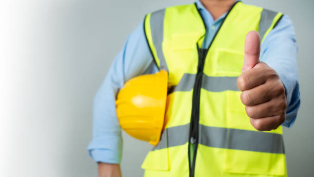istock Civil engineer architect standing holding a safety helmet on grey background, Construction site plans to build high-rise buildings, Engineer building concept, Background for construction. 2153829894
