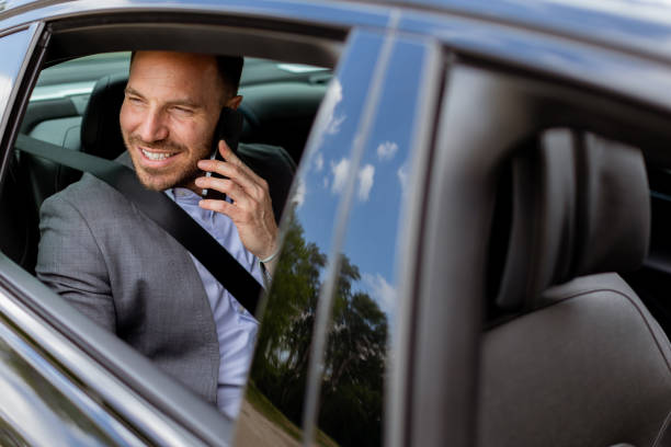 istock Joyful man sharing laughter on a phone call while driving in daylight 2153830382