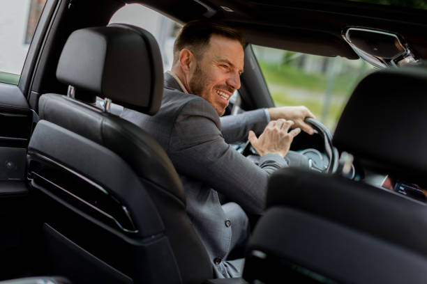 istock Businessman expressing intense emotion while driving car in urban setting 2153830393