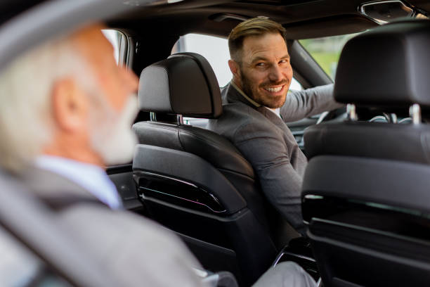 istock Businessmen sharing a laugh during morning commute in a car 2153830532