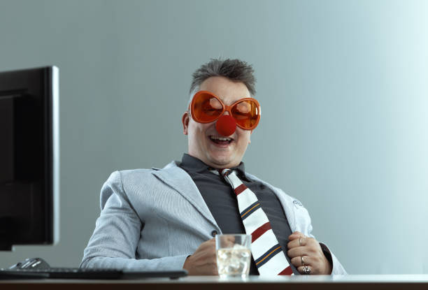 istock Drinking man in suit, ridiculous clown attire 2153832573