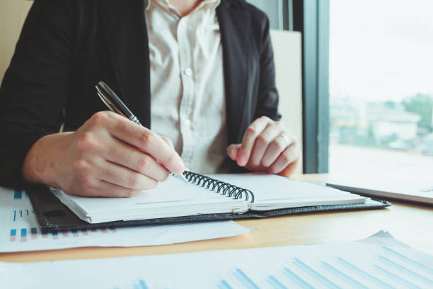 istock A student intensely studying and writing in a notebook, preparing for an upcoming exam in a university classroom setting, highlighting the importance of education and academic success 2153833794