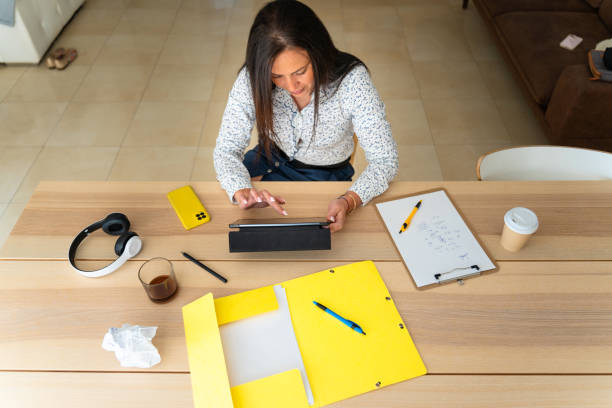 istock Middle aged Romanian businesswoman using a tablet to telework 2153835041