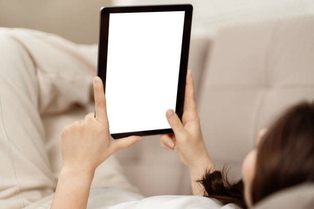 istock Young Woman Relaxing In Bed Browsing Tablet At Home 2153835469