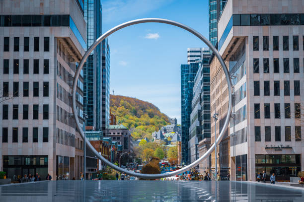 The Ring (L’Anneau) a sculpture and tourist attraction located at the Place Ville Marie in downtown Montreal, with Mount Royal in the backdrop, province of Quebec, Canada. Photo taken in (May 2024).
