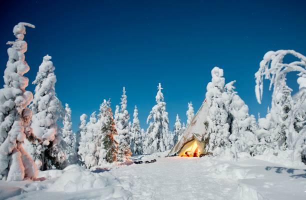 istock Teepee with campfire in the snow on a clear night 2153837020