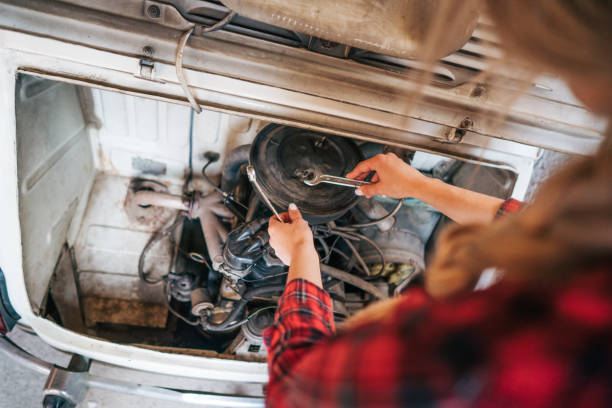 istock young woman repair old timer car 2153841846