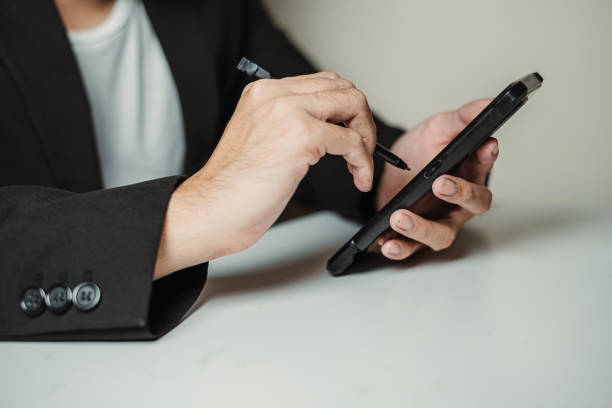 istock Hand of Professional Man Working on a Smartphone using Stylus 2153844159