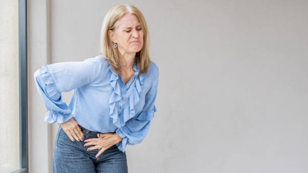 istock A blonde woman is suffering because she has appendix pain. 2153844319