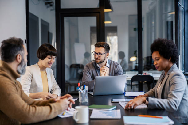 istock A chief sitting with his interracial coworkers and having briefing. 2153845221
