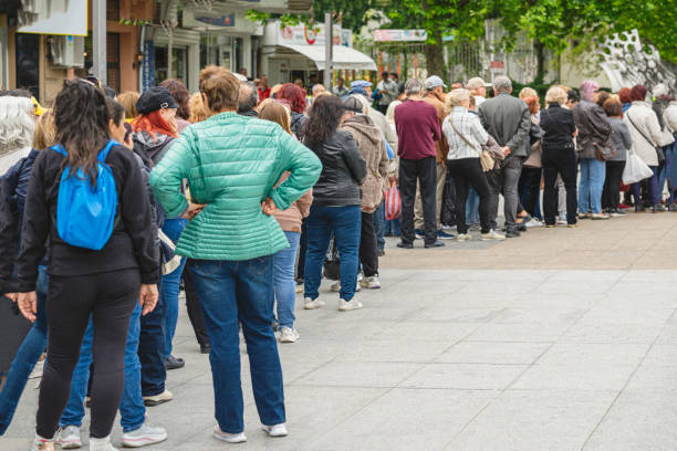 istock Unrecognizable people standing in queue outdoors, municipal or other public event 2153845890