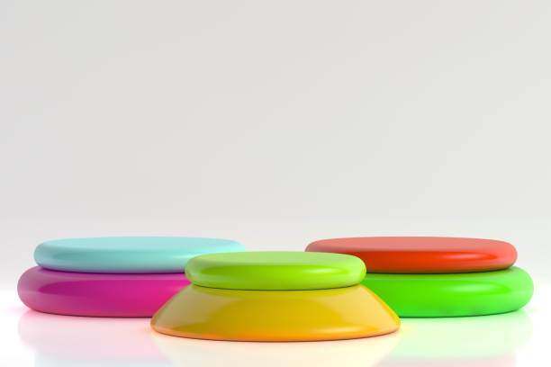Colorful objects standing in a row on white background, empty stage for product presentation