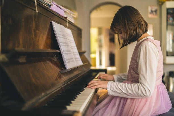 istock Girl playing grand piano 2153853714