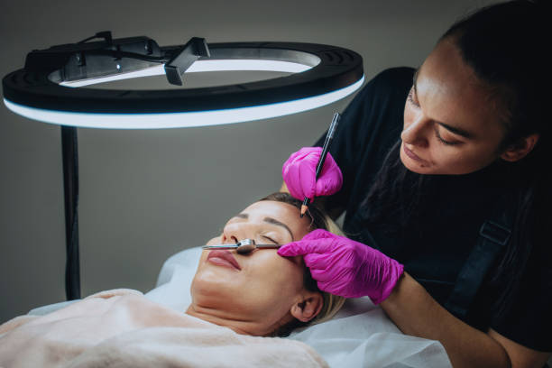 istock Beautician applying permanent make up to a customer in a beauty salon 2153853992