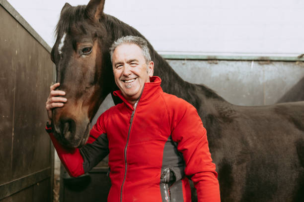 istock Happy man showing bond with his horse before riding. 2153854906