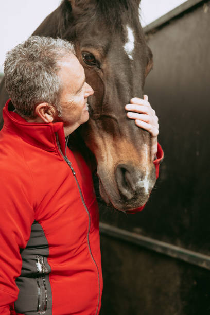 istock Man enjoying the interaction he has with the horse he rides. 2153854928