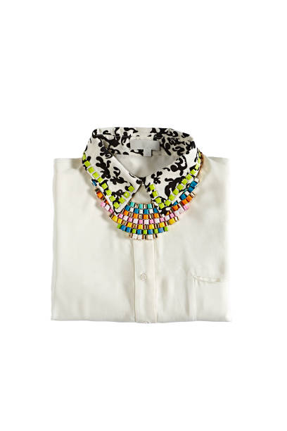A variety of colorful beaded necklaces and bracelets laid out on a surface. Some beads are round and smooth, while others are irregularly shaped.