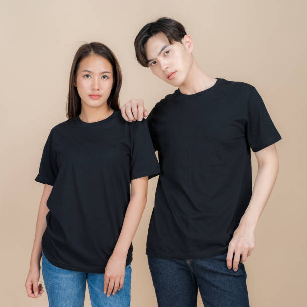 istock Stylish couple posing in plain black t-shirts 2153857612