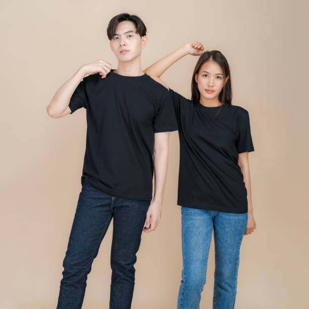 istock Stylish couple posing in plain black t-shirts 2153857656