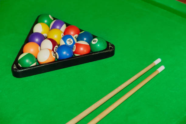 istock Billiard balls and two cues on a billiard table, playing billiards, close-up 2153858773