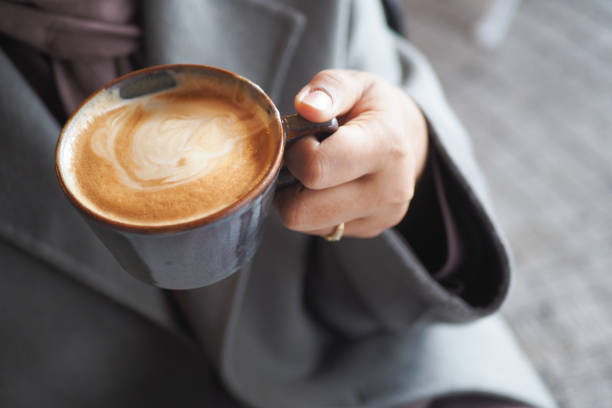 istock women holding a coffee cup 2153859449