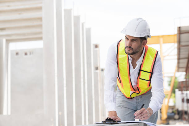 istock Male engineer construction working and inspecting structure of building at construction site. Male construction builder working at construction site 2153861402