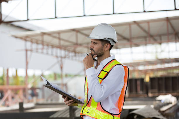 istock Male engineer construction working and inspecting structure of building at construction site. Male construction builder working at construction site 2153861405