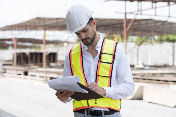 istock Male engineer construction working and inspecting structure of building at construction site. Male construction builder working at construction site 2153861618