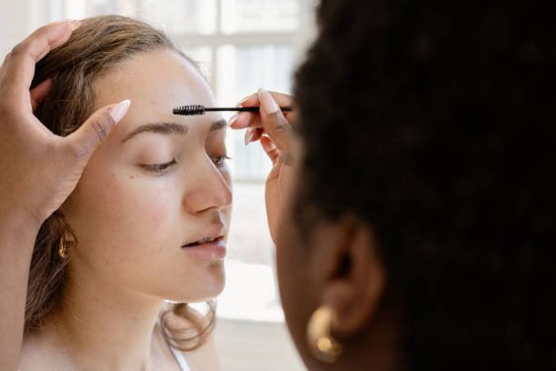 istock Makeup artist applying makeup to model 2153861738