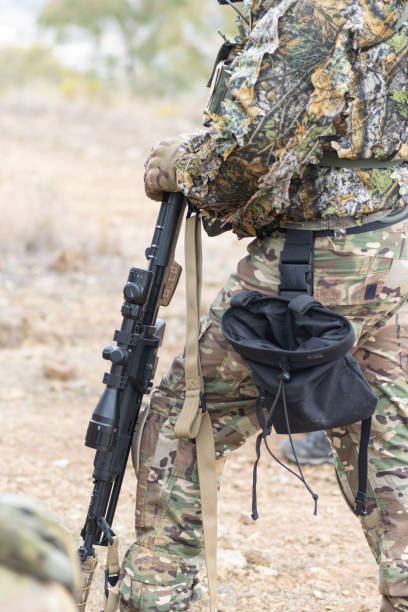 istock Soldier airsoft player dressed in camouflage uniform wielding a sniper rifle 2153863640