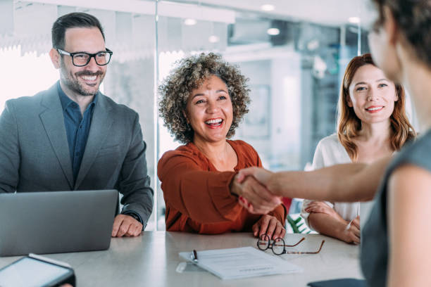 istock Businesspeople shaking hands across the table. 2153864765
