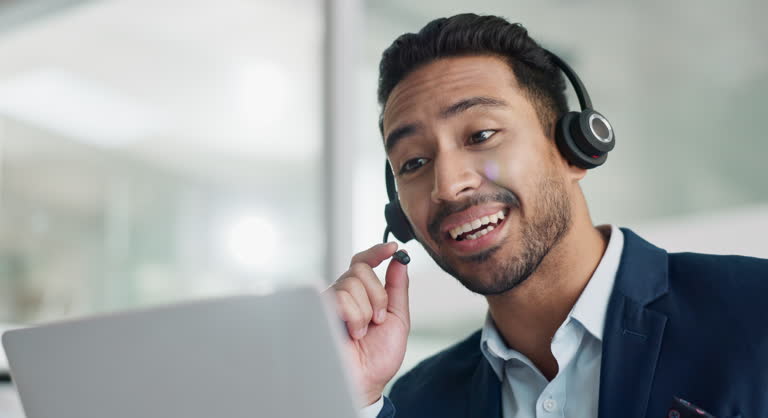 Laptop, problem solving and business man in call center with headset for customer support or service. Smile, computer and consulting with happy employee working in tech agency for contact us online