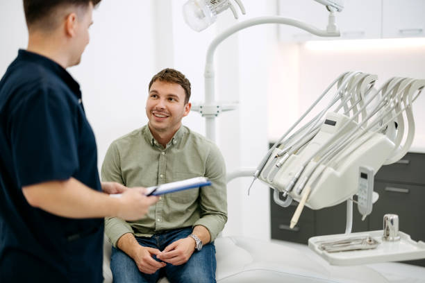 istock Male  dentist and patient 2153866630