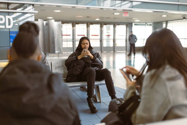 istock Diverse Female Students at Ferry Terminal with Smartphones 2153866975