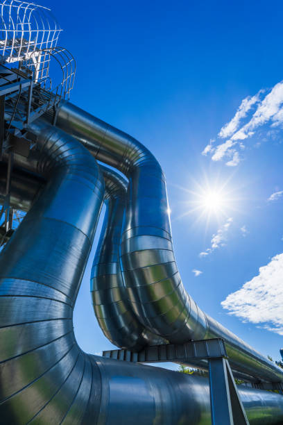 Industrial pipelines on pipe-bridge against blue sky