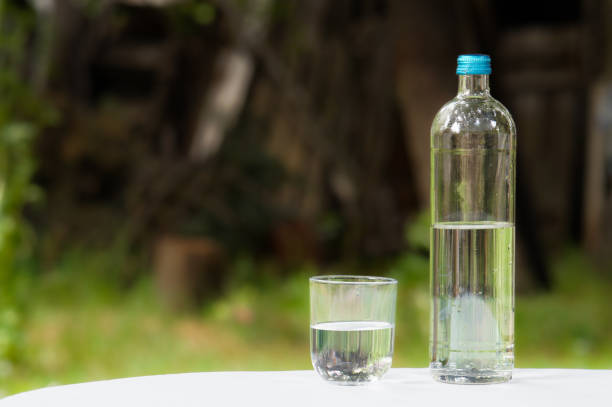 istock glass of water and bottle copy space selective focus on foreground, blurred background 2153868170