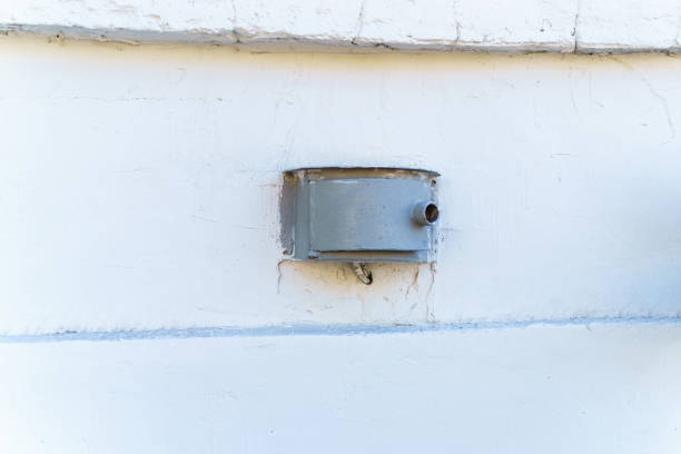 Cylindrical metal cabinet embedded in a concrete wall for infrastructure