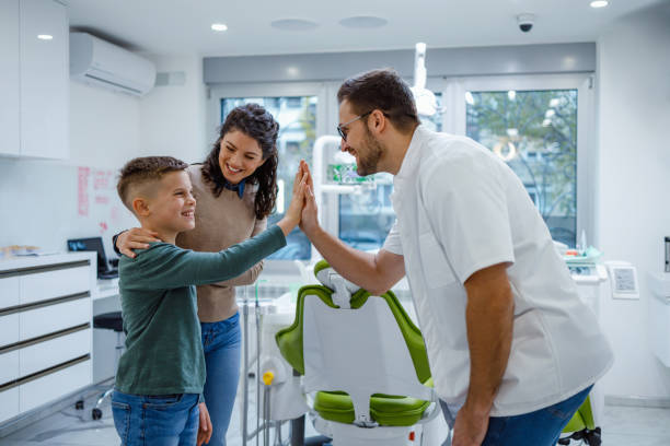 istock Dentist giving high five to young boy 2153871512