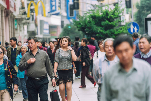 Editorial photo capturing a busy street in Shanghai, China with pedestrians walking on October 28, 2015. The photo portrays daily life and urban hustle.