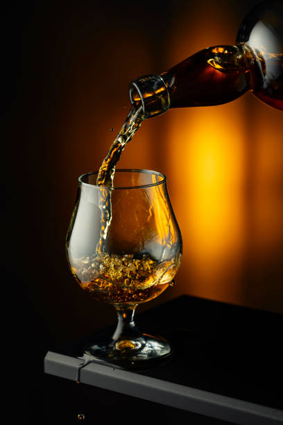 istock Cognac or brandy being poured into a glass. 2153874112