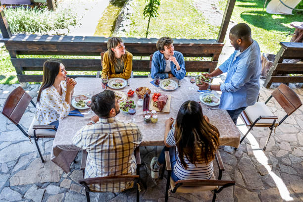 istock Man serving meal for friends in the backyard 2153875034
