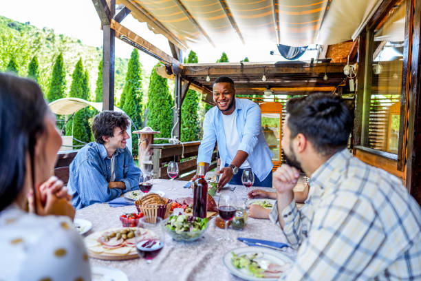 istock Man serving meal for friends in the backyard 2153875313