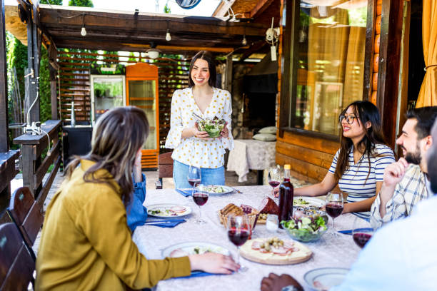 istock Woman setting up the table for lunch with her friends 2153875397