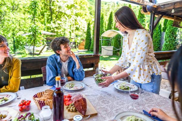 istock Woman setting up the table for lunch with her friends 2153875702