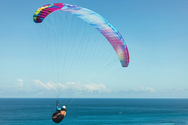 istock Paraglider flies in front of the ocean 2153876095