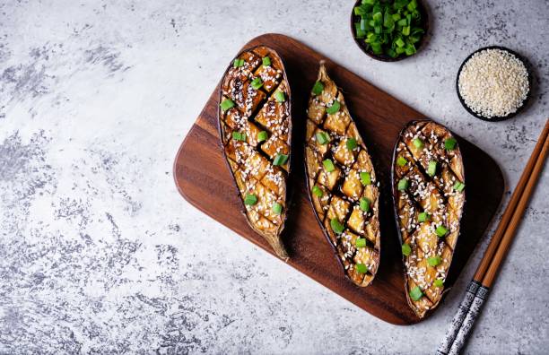 istock Teriyaki sesame seed baked eggplant in a cut board 2153877695