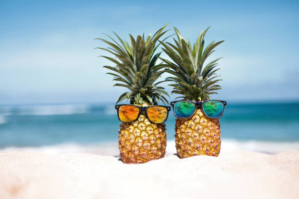 istock Two pineapples with trendy sunglasses in tropical paradise 2153879262